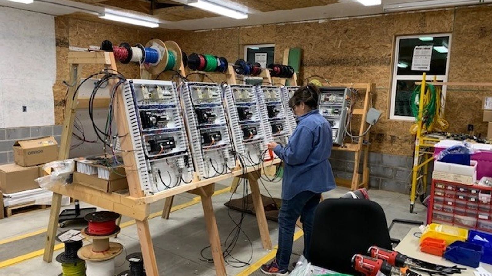 JASS Automation team member fabricating electrical control panels